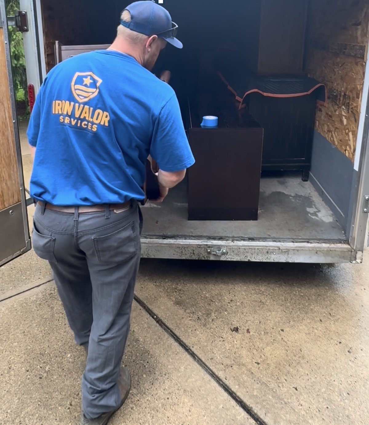 Securing furniture inside the enclosed trailer for a donation run.
